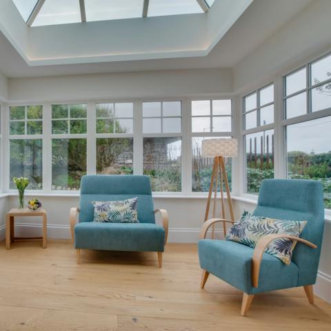 Read a book in the tranquil setting of the conservatory