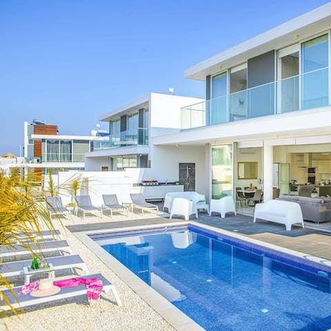 Soak up the sun on a lounger beside the private heated pool