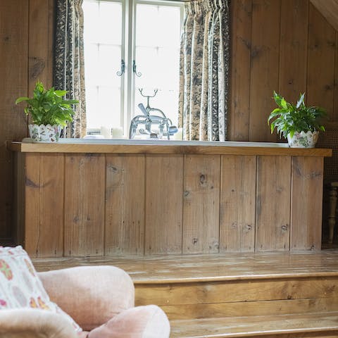Enjoy a soak in the wood-framed bathtub