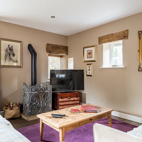 Get cosy on colder nights by lighting the wood-burning stove