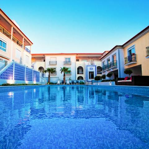 Go for a float in the communal pool under the clear blue Portuguese skies