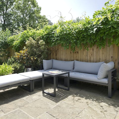 Enjoy sipping your morning coffee in the blooming back garden