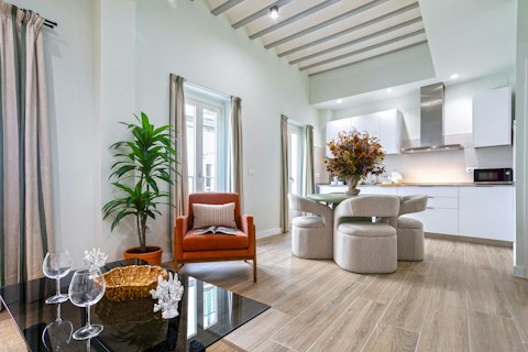 Gather in a light-filled room with exposed beam ceilings