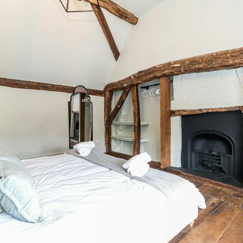 Feel the warmth of the fire from the king-size bed