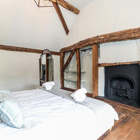 Feel the warmth of the fire from the king-size bed