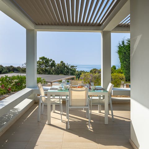 Gather together for an alfresco feast while savouring sea views in the distance