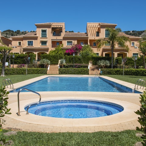 Luxuriate in the communal outdoor pool surrounded by lush greenery