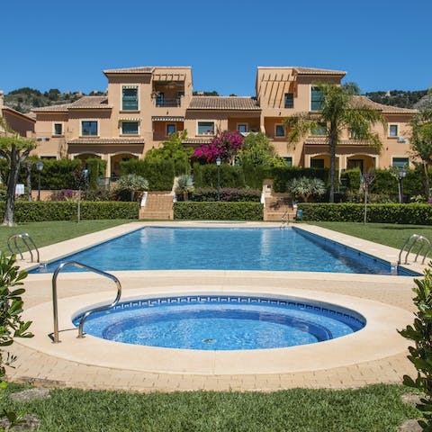 Luxuriate in the communal outdoor pool surrounded by lush greenery