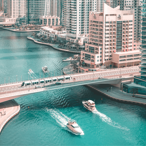 Explore the Dubai Marina, boasting high-end retailers and a skydiving centre