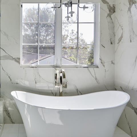 Sink into the deep free-standing bathtub