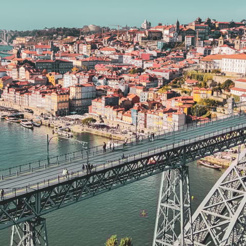 Cross the Luís I Bridge to explore Porto's bustling Cais da Ribeira area