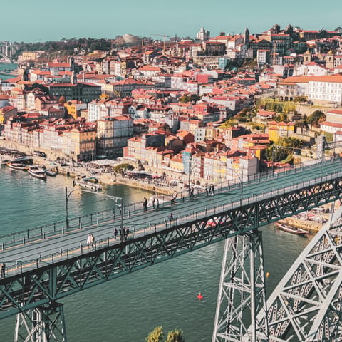Cross the Luís I Bridge to explore Porto's bustling Cais da Ribeira area