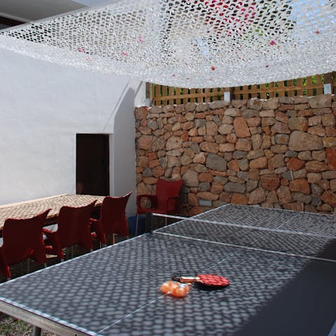 Enjoy a game of ping pong in the shade