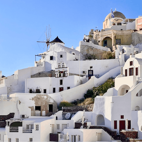 Discover the whitewashed buildings and winding paths of Mykonos island
