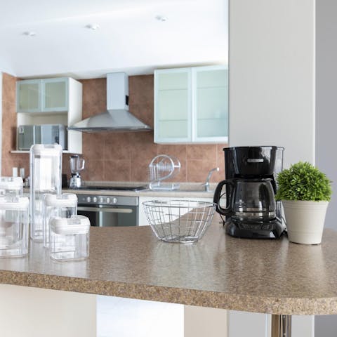 Kickstart your day with freshly brewed coffee in the sleek kitchen