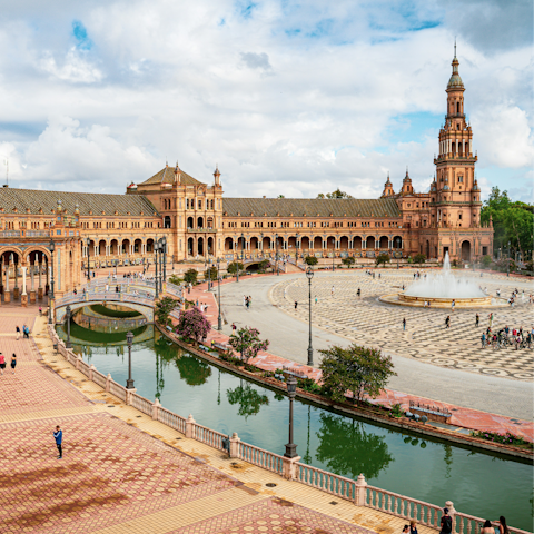 Wander through Plaza de España and admire its grand architecture and scenic canal
