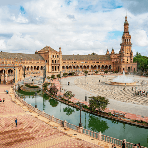 Wander through Plaza de España and admire its grand architecture and scenic canal