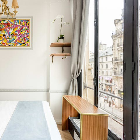 Watch the world go by from a comfy spot in bed through the French doors