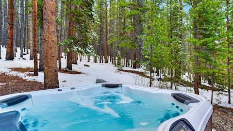 Bubble away in the Jacuzzi while snow blankets the treetops
