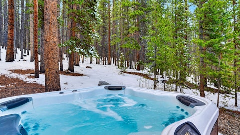 Bubble away in the Jacuzzi while snow blankets the treetops