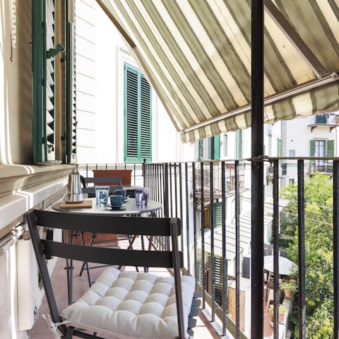 Enjoy coffee and people-watching from the private balcony