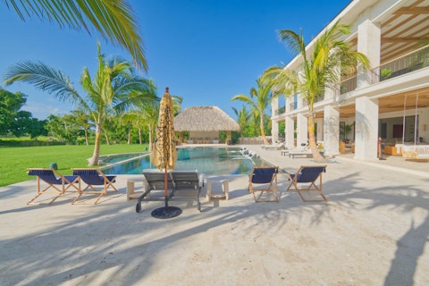 Cool off in the pool as palm trees shade the lawn