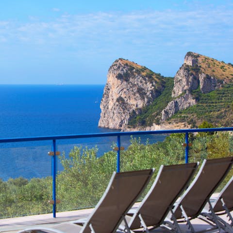 Admire the Mediterranean Sea views while relaxing on a sunlounger