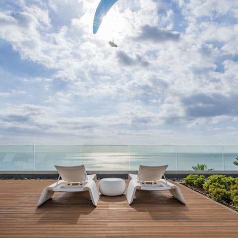 Take in the idyllic sea views as you sip cocktails on a sun lounger