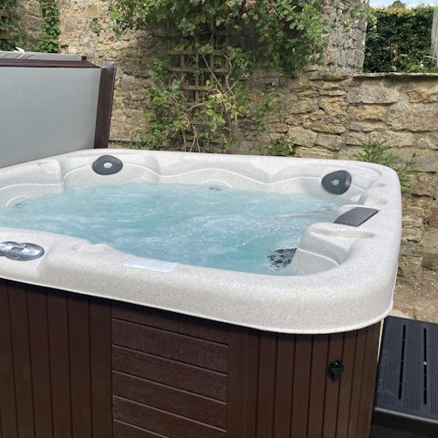 Unwind in the hot tub and enjoy beautiful views of the gardens