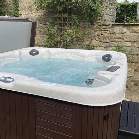 Unwind in the hot tub and enjoy beautiful views of the gardens
