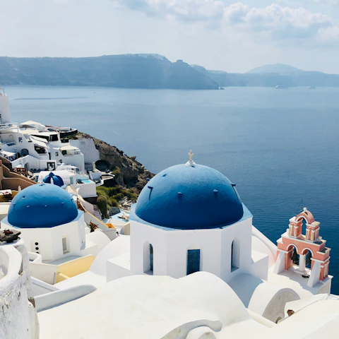 Discover the iconic blue domes in Oia village, twenty minutes away