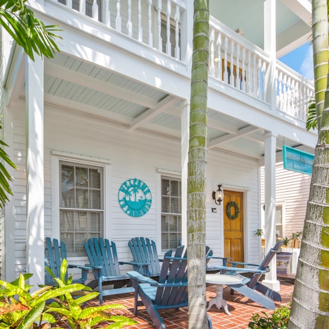 Bask under the shady porch of this classic wooden home