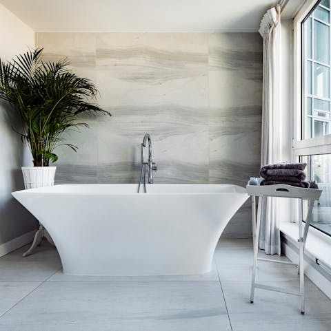 Sink into the deep free-standing bathtub