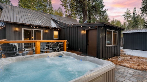 Enjoy the hot tub into the evening beneath a pine-fringed sunset sky