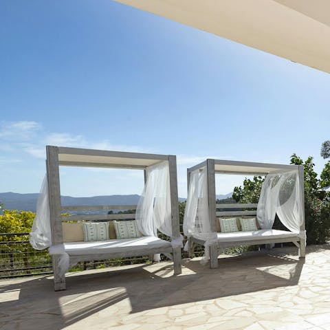 Stretch out on the shaded lounge beds with a book