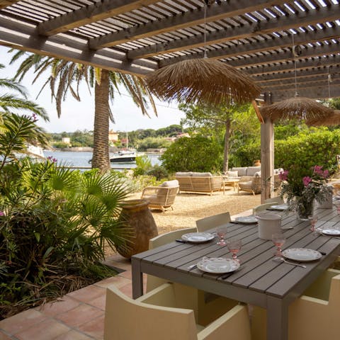 Gather at the outdoor dining table for alfresco dinners under dappled sunlight