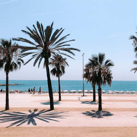 Take a fifteen-minute stroll down to the palm-lined shores of Barceloneta Beach
