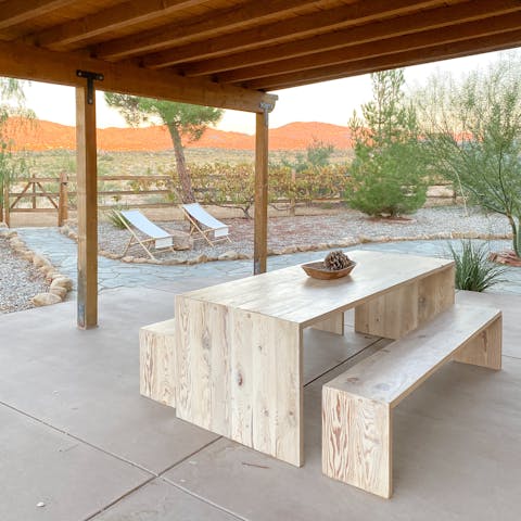 Eat outdoors together at the covered dining table