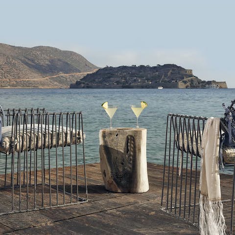 Sip sundowners looking out over the water towards Spinalonga
