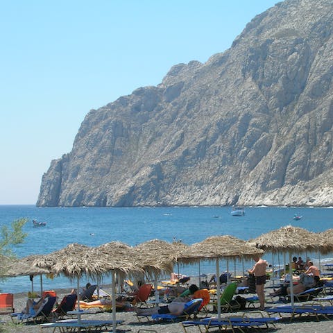 Reach the black pebble Kamari beach in just twenty minutes by car