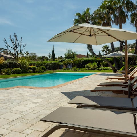 Relax and unwind by the pool, cool drink in hand