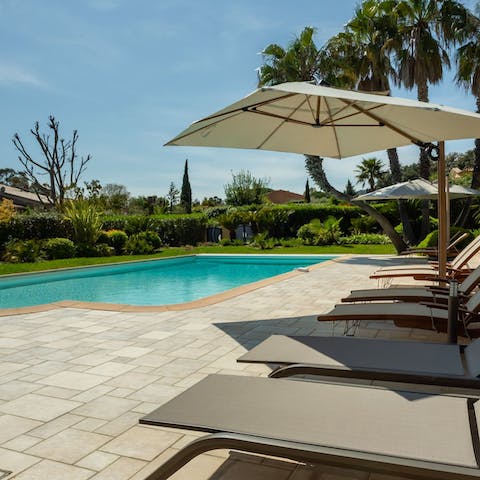 Relax and unwind by the pool, cool drink in hand