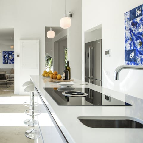 Rustle up a meal in the sleek kitchen or hire a private chef to do the cooking for you