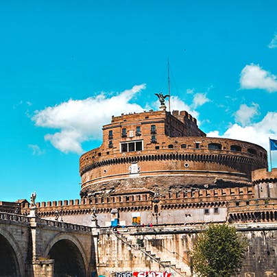 Cross the River Tiber to visit Castel Sant'Angelo