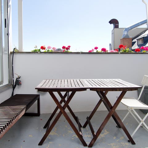 Relax under the sun on the terrace with a glass of red