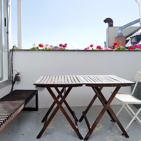 Relax under the sun on the terrace with a glass of red