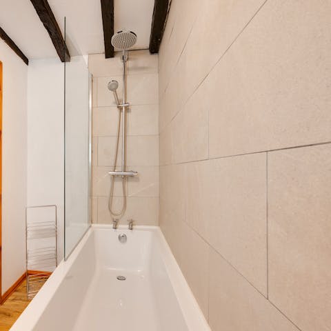 Refresh in the rain shower and soak in the bathtub