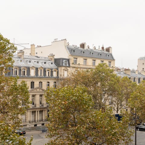 Take in the views over the trees and Parisian architecture from the balcony