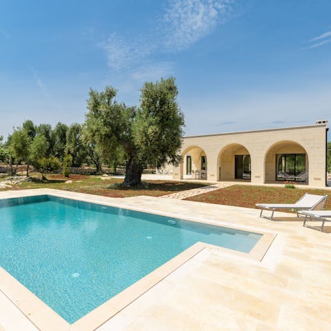 Relax beside the sun-kissed swimming pool