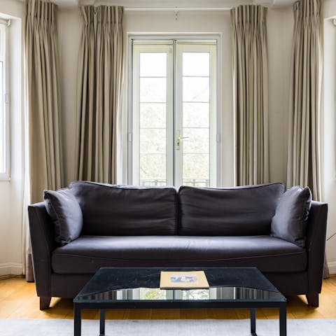 Sink into the plush sofa with a glass of wine, admiring the views from the Juliet balcony